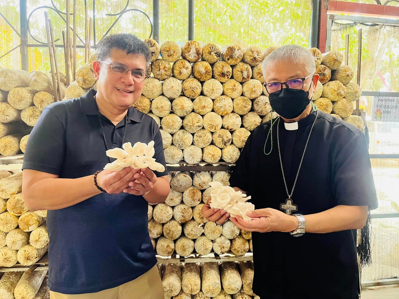 Fr. Arnold Abelardo with a partner at an Ako Ang Saklay mushroom livelihood activity